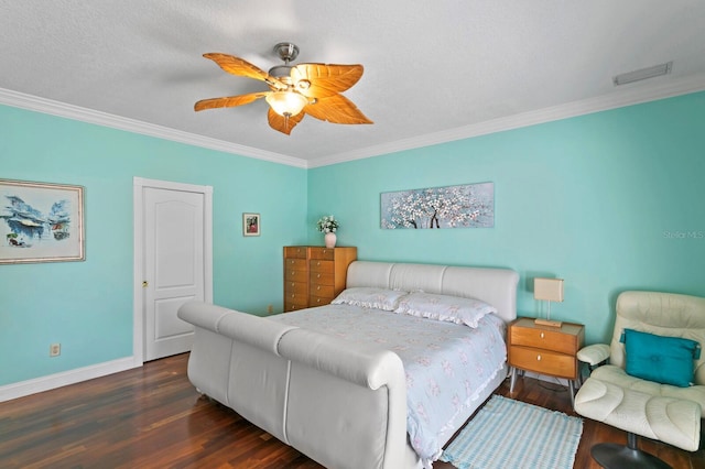 bedroom featuring a ceiling fan, visible vents, crown molding, wood finished floors, and baseboards