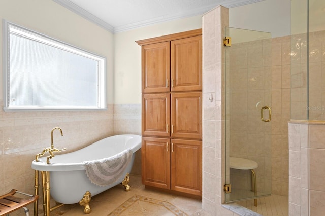 full bathroom featuring crown molding, a freestanding tub, a shower stall, and tile walls