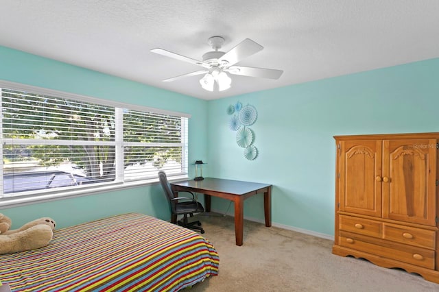 bedroom featuring light colored carpet, a ceiling fan, and baseboards