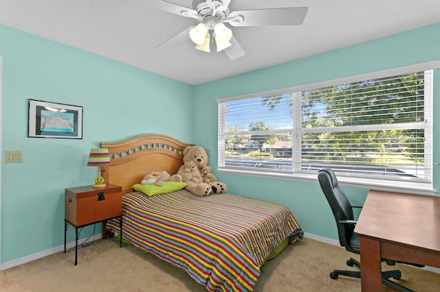carpeted bedroom featuring baseboards and a ceiling fan