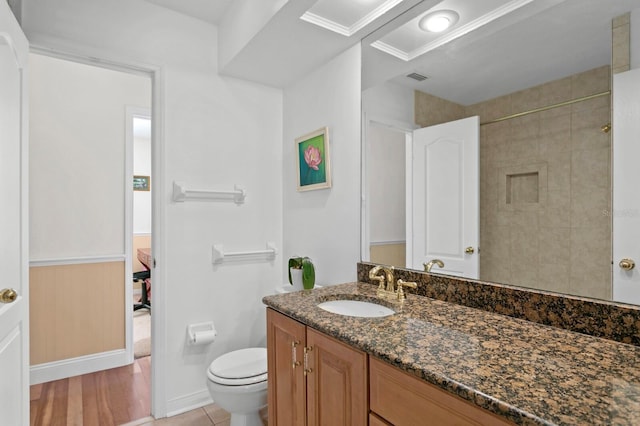 ensuite bathroom with walk in shower, vanity, toilet, ensuite bathroom, and visible vents