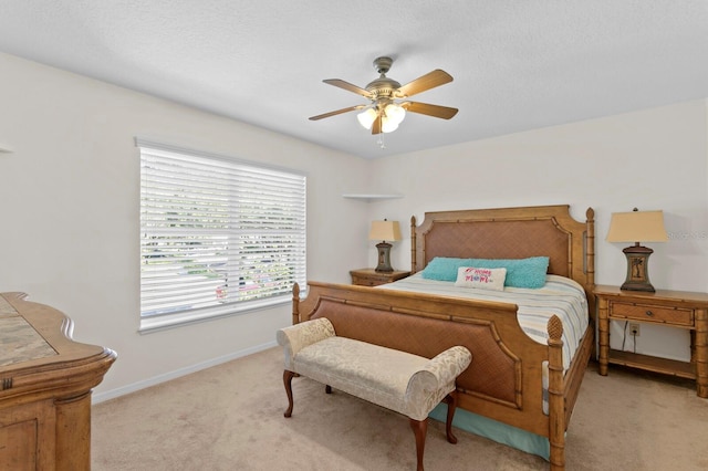 bedroom with baseboards, light carpet, and a ceiling fan