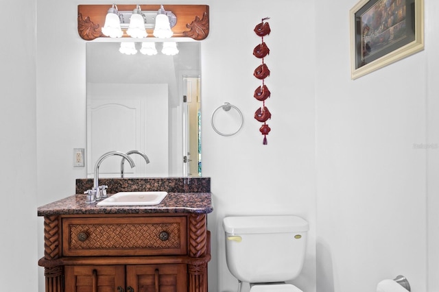 bathroom featuring toilet and vanity