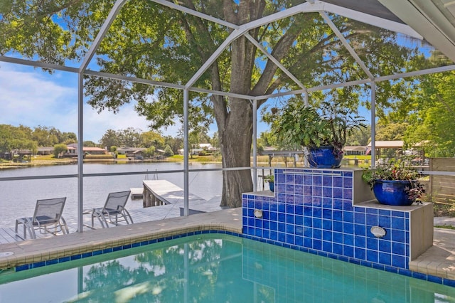 outdoor pool featuring a patio, a water view, and a lanai
