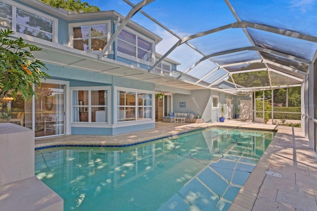 pool featuring an outdoor living space, a lanai, and a patio area
