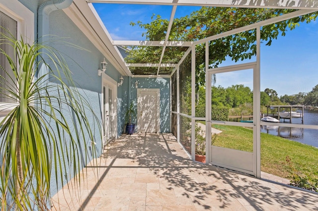 unfurnished sunroom featuring a water view