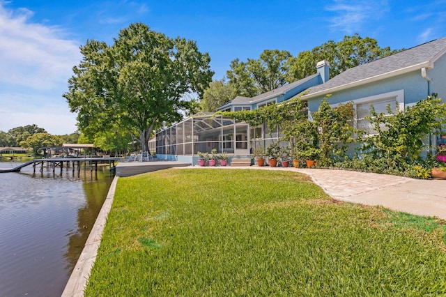 view of yard featuring a water view and a dock