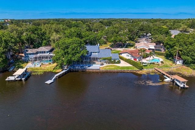 birds eye view of property featuring a water view and a forest view