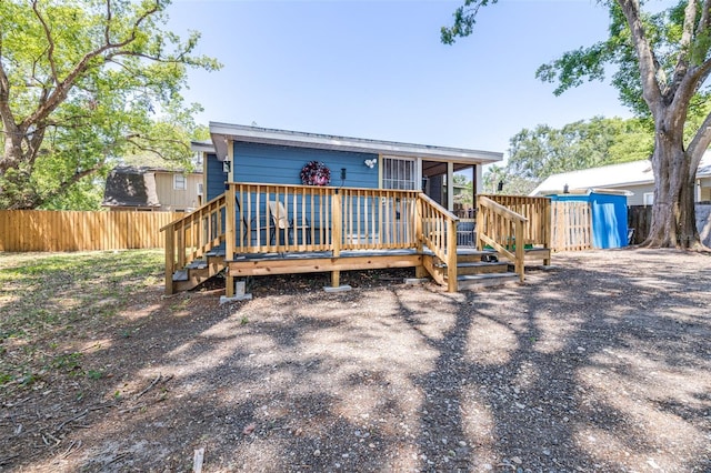 5304 Cherry Ave, Seffner, FL 33584 - view of front of house featuring a fenced backyard, a wooden deck, a sunroom, and stairway