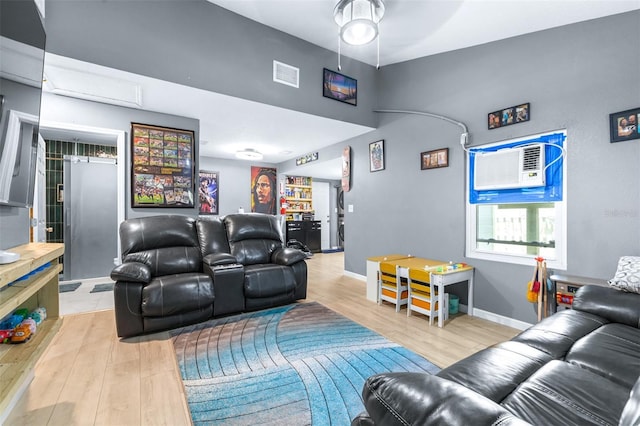 5304 Cherry Ave, Seffner, FL 33584 - living room featuring a ceiling fan, visible vents, a wall mounted AC, baseboards, and light wood finished floors