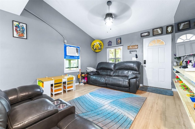 5304 Cherry Ave, Seffner, FL 33584 - living area with baseboards, a wall mounted air conditioner, ceiling fan, light wood finished floors, and vaulted ceiling