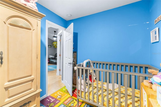 5304 Cherry Ave, Seffner, FL 33584 - bedroom with a nursery area and wood finished floors