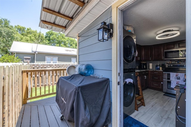 5304 Cherry Ave, Seffner, FL 33584 - laundry area featuring laundry area, wood walls, stacked washer / dryer, and light wood-style floors