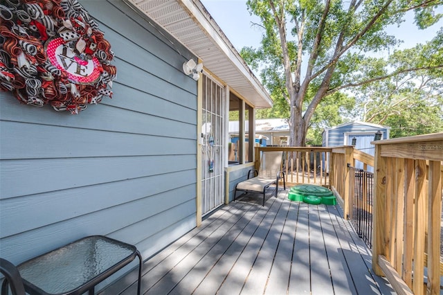 5304 Cherry Ave, Seffner, FL 33584 - wooden terrace featuring a shed and an outbuilding