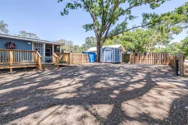 5304 Cherry Ave, Seffner, FL 33584 - view of yard with fence, a storage unit, a wooden deck, a sunroom, and an outdoor structure