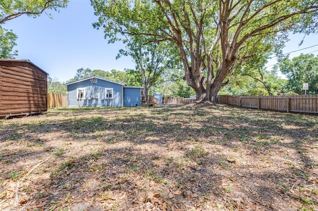 5304 Cherry Ave, Seffner, FL 33584 - view of yard with a fenced backyard, an outbuilding, and a storage shed