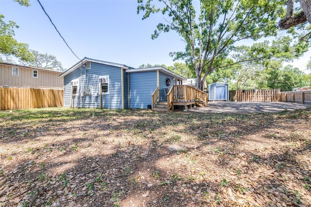 5304 Cherry Ave, Seffner, FL 33584 - rear view of property with an outdoor structure, a fenced backyard, a storage shed, and a deck