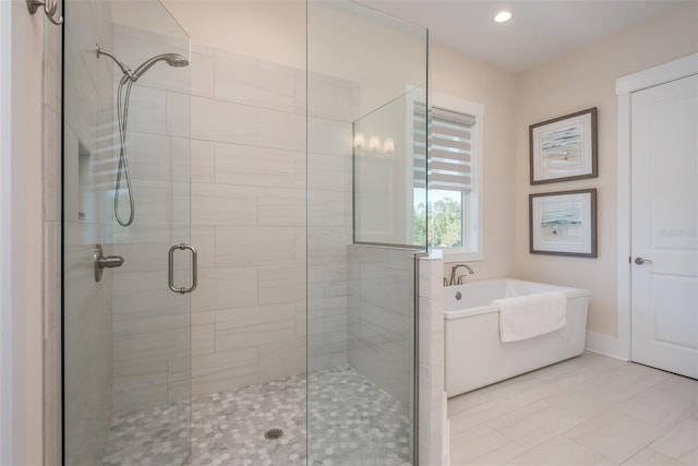 full bathroom featuring a shower stall, a garden tub, tile patterned floors, baseboards, and recessed lighting