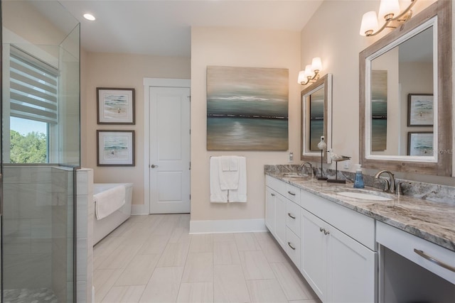 bathroom with baseboards, double vanity, a bath, recessed lighting, and a shower with shower door