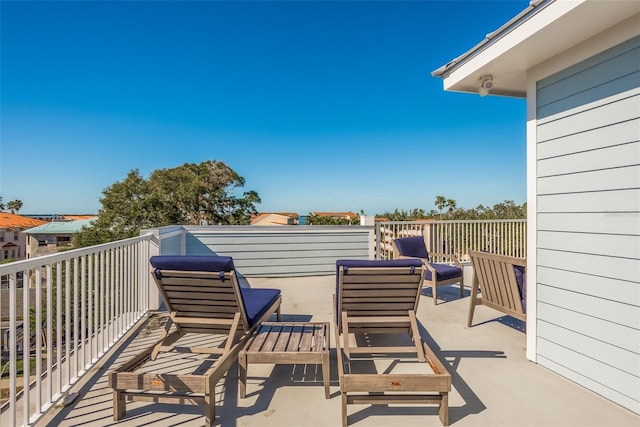 view of patio with an outdoor living space and a balcony