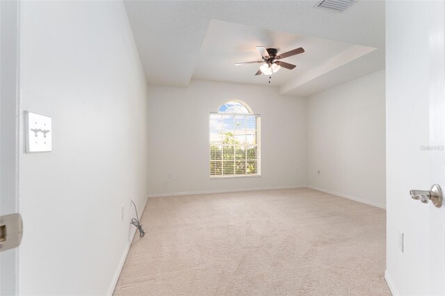 carpeted empty room featuring visible vents, baseboards, and ceiling fan