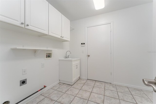 laundry area with hookup for a washing machine, gas dryer hookup, electric dryer hookup, cabinet space, and light tile patterned floors