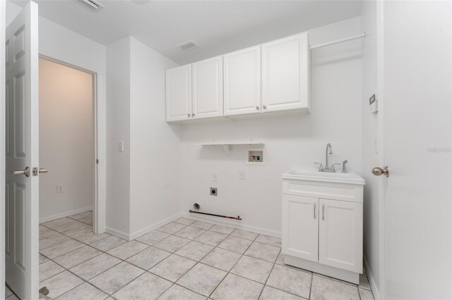 laundry area with visible vents, cabinet space, electric dryer hookup, a sink, and washer hookup