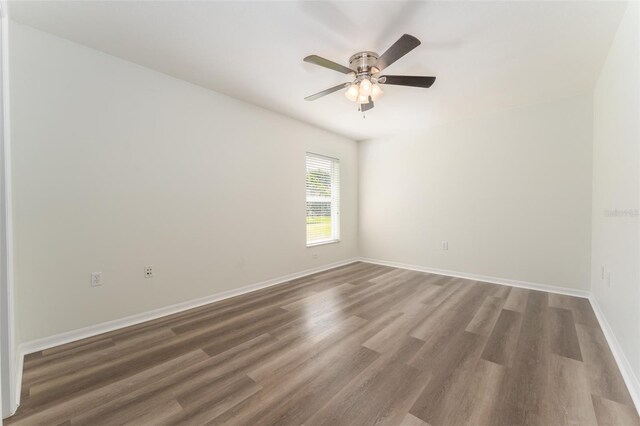 unfurnished room featuring baseboards, ceiling fan, and wood finished floors