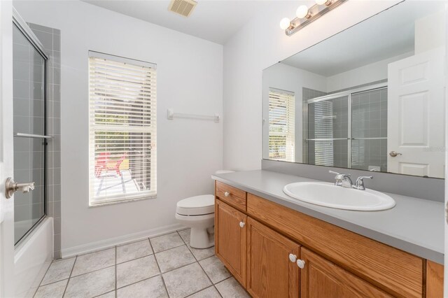 bathroom with toilet, visible vents, a healthy amount of sunlight, and vanity