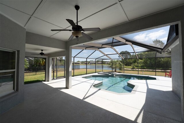 view of swimming pool with a patio, a ceiling fan, a water view, a lanai, and a pool with connected hot tub