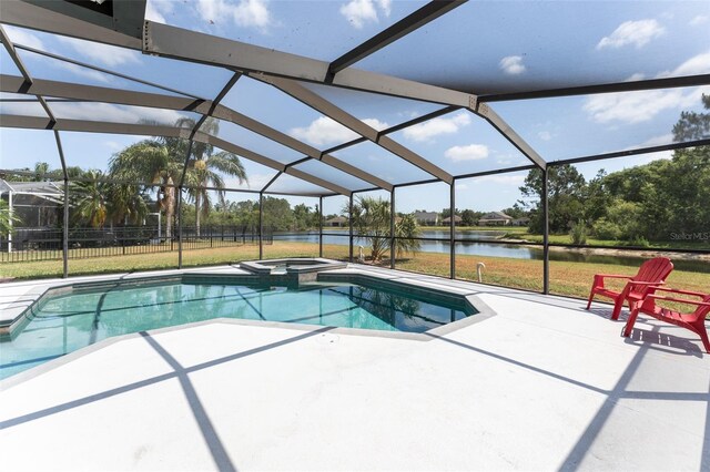view of pool with a lanai, a patio, a water view, and a pool with connected hot tub