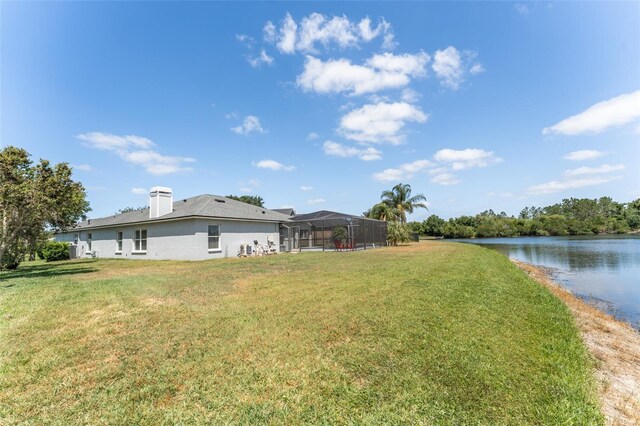view of yard featuring a water view and a lanai