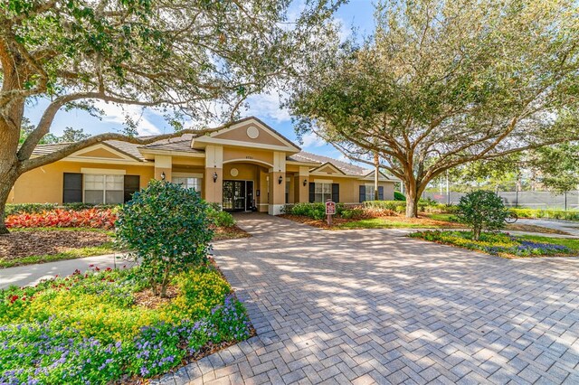 view of front of house with a tile roof and stucco siding