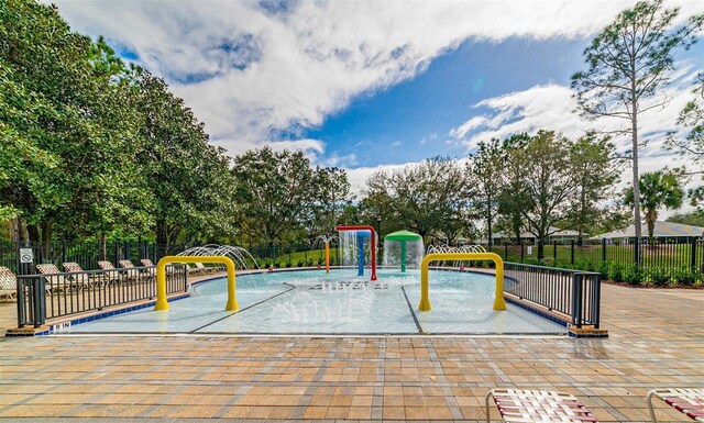 view of jungle gym featuring fence