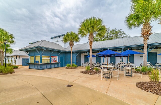 exterior space featuring a patio area and metal roof