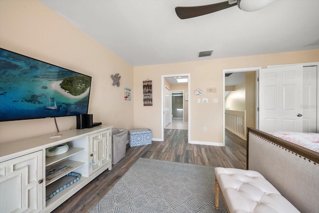 bedroom with dark wood-style flooring, baseboards, visible vents, and ceiling fan