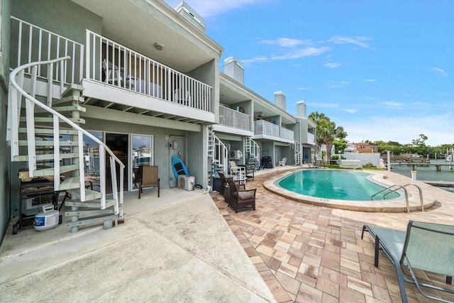pool featuring a patio and stairway