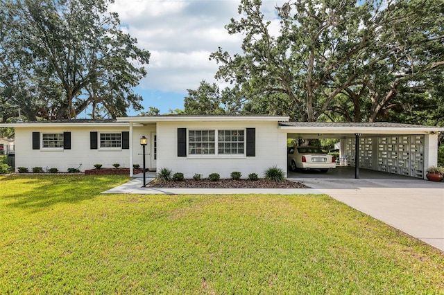 single story home featuring a front lawn, driveway, and a carport