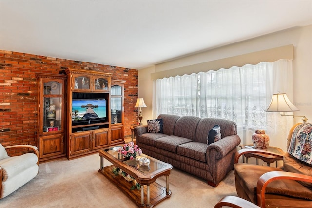 living room with light colored carpet and brick wall