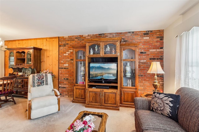 living area featuring light colored carpet and wooden walls