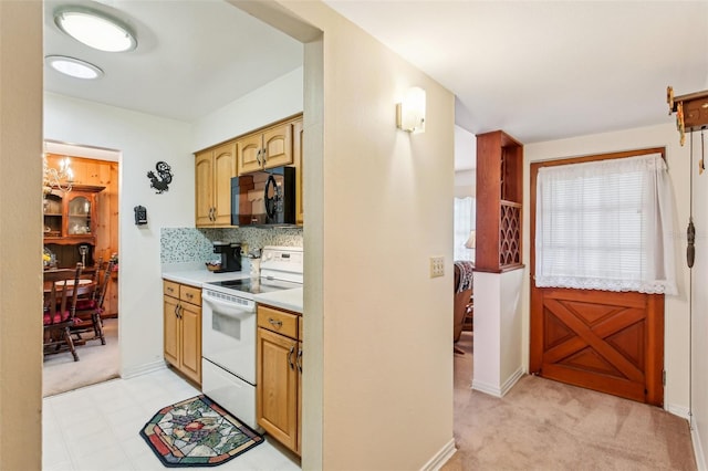 kitchen with light countertops, white range with electric stovetop, light carpet, and black microwave
