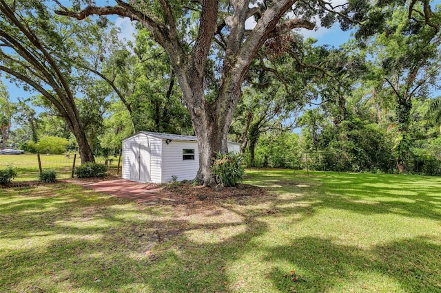 view of yard with an outbuilding and a shed