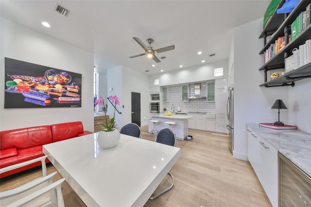 dining room with recessed lighting, ceiling fan, light wood finished floors, and visible vents