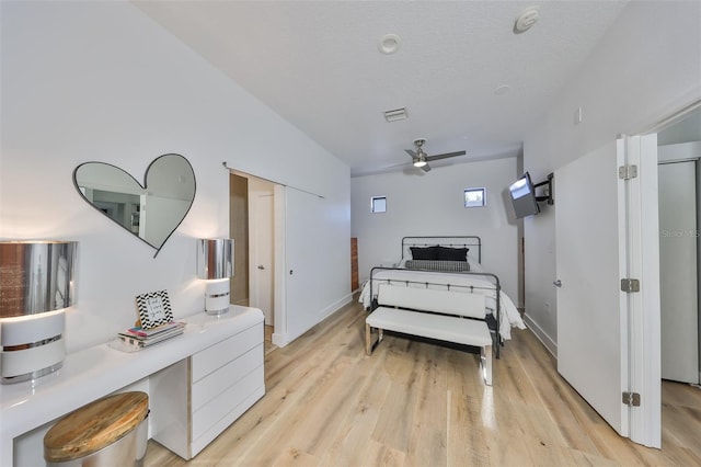 living area featuring visible vents, a ceiling fan, light wood-style floors, and baseboards
