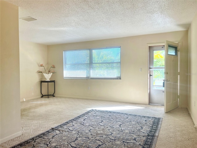 3128 59th St S Unit 206, Gulfport, FL 33707 - interior space featuring visible vents, a textured ceiling, carpet, and baseboards