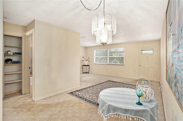 3128 59th St S Unit 206, Gulfport, FL 33707 - dining area with carpet flooring, a textured ceiling, a notable chandelier, and baseboards