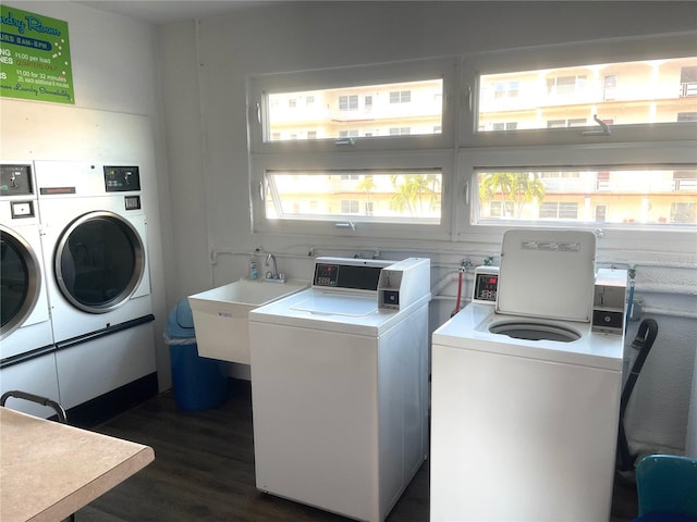 3128 59th St S Unit 206, Gulfport, FL 33707 - common laundry area featuring a sink, washer and clothes dryer, and dark wood finished floors