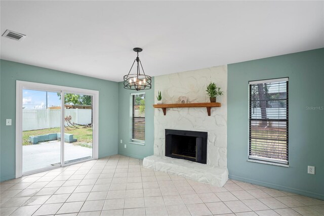 3353 Montano Ave, Spring Hill, FL 34609 - unfurnished living room with baseboards, a stone fireplace, an inviting chandelier, and visible vents