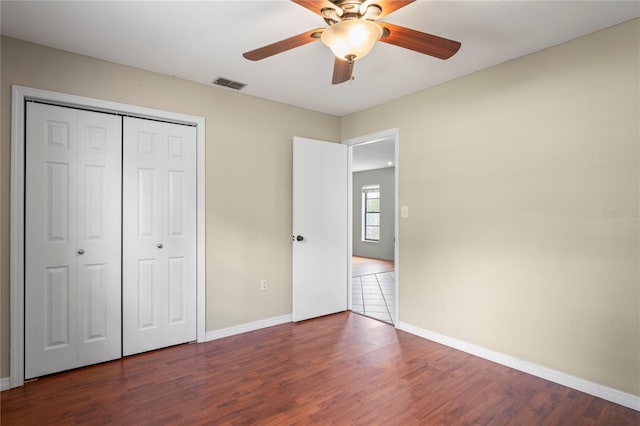 3353 Montano Ave, Spring Hill, FL 34609 - unfurnished bedroom with baseboards, a closet, visible vents, and wood finished floors