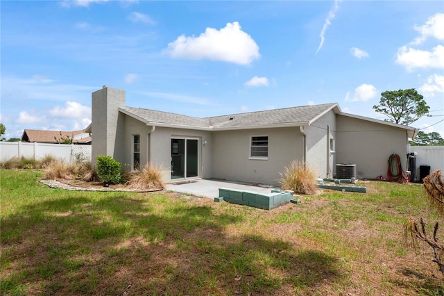 3353 Montano Ave, Spring Hill, FL 34609 - rear view of house with fence, a patio area, stucco siding, cooling unit, and a lawn